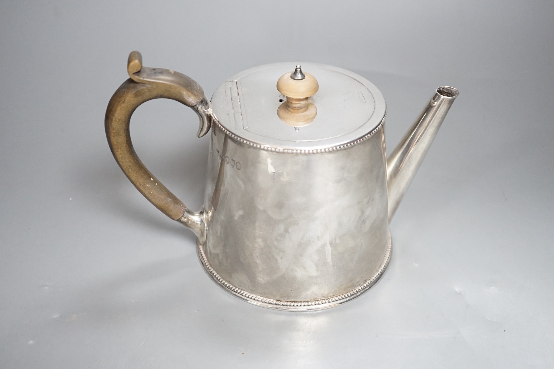 A late Victorian silver teapot, of cylindrical tapering form, William Comyns, London, 1883, gross 15oz.